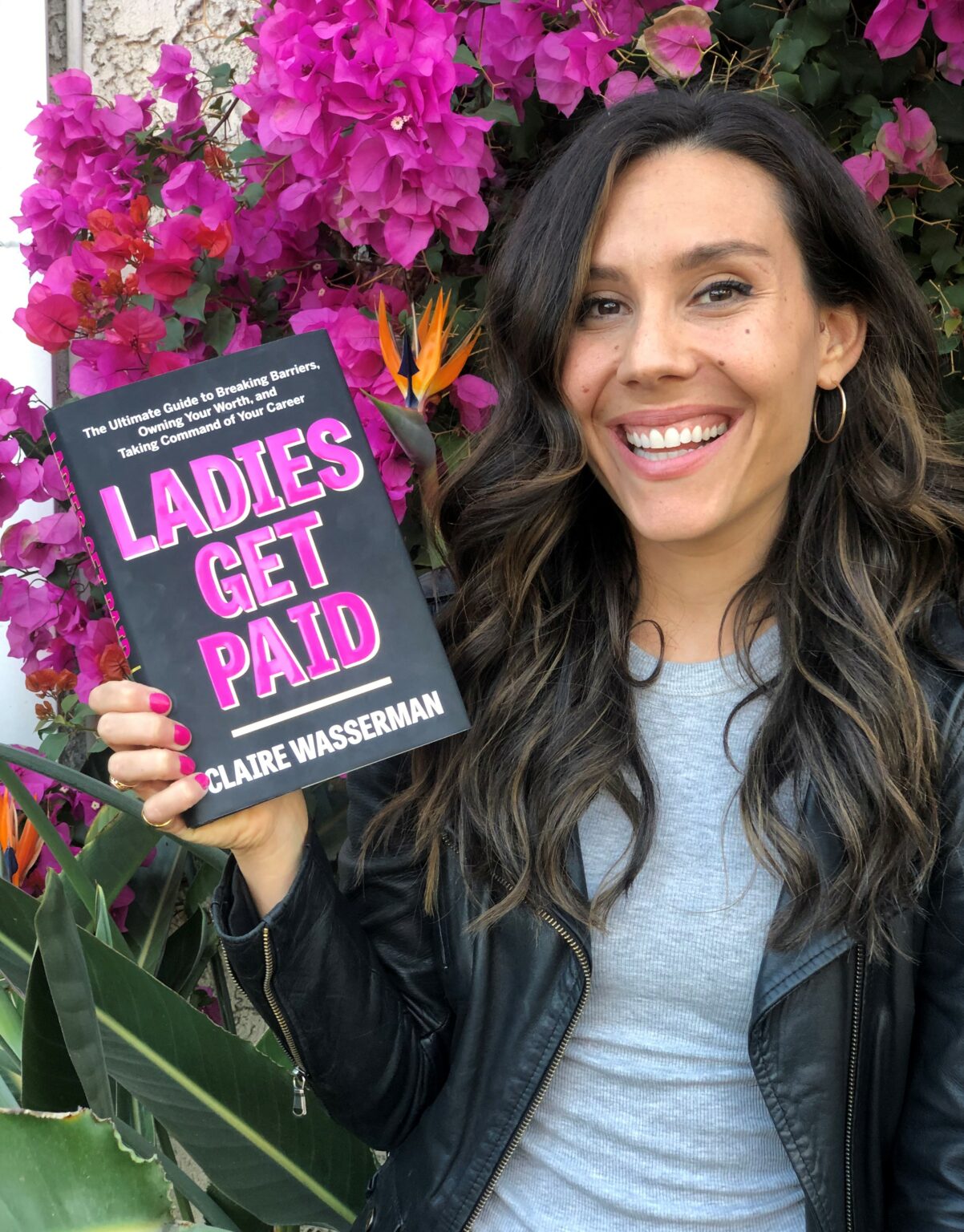 Claire Wasserman holding her book, Ladies Get Paid
