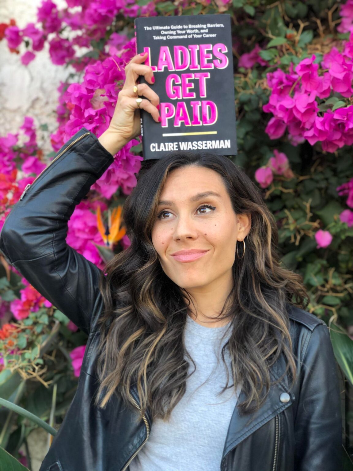 Claire Wasserman holding her book, Ladies Get Paid
